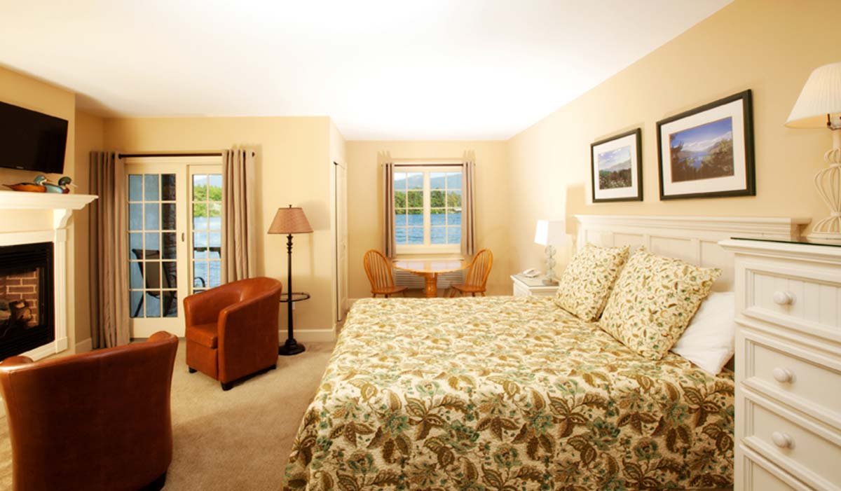 Floral print bed and fireplace in bedroom suite